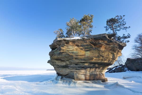 This sea stack of rock, known as Turnip Rock, rises from the ice of a frozen Lake Huron in winter. It is located near the tip of the thumb in Port Austin Michigan