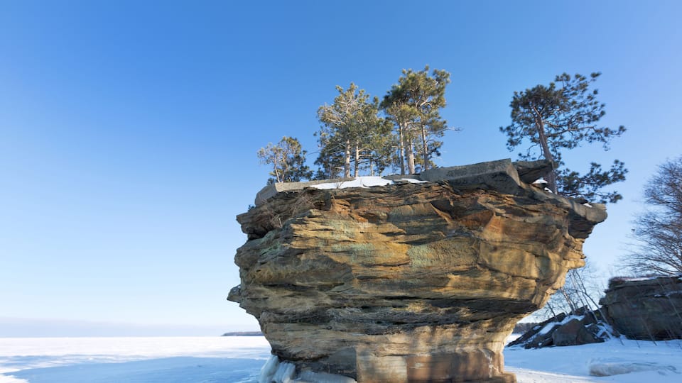 This sea stack of rock, known as Turnip Rock, rises from the ice of a frozen Lake Huron in winter. It is located near the tip of the thumb in Port Austin Michigan