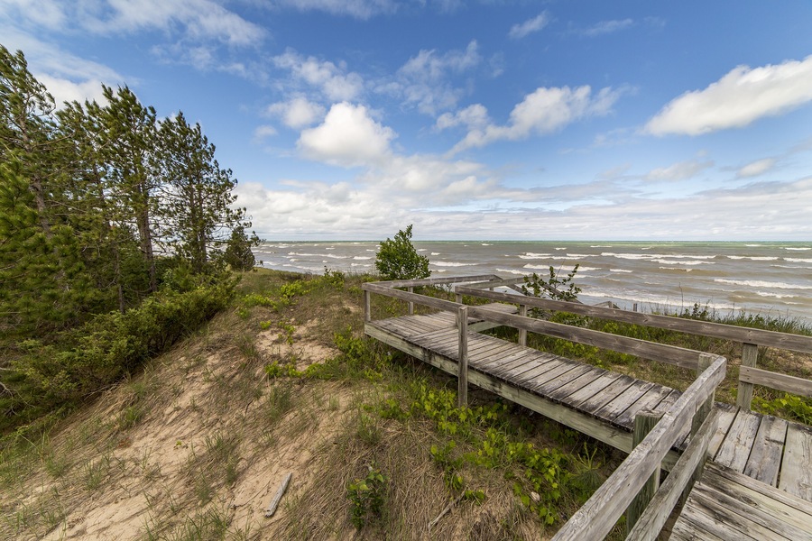 A boardwalk traverses a sensitive Lake Huron dune ecosystem, protecting the vegetation and providing easy access to the beach - Grand Bend, Ontario ; Shutterstock ID 576675400; Purchase Order: -