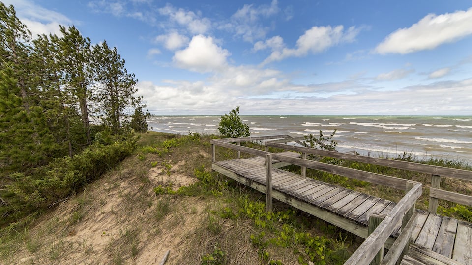 A boardwalk traverses a sensitive Lake Huron dune ecosystem, protecting the vegetation and providing easy access to the beach - Grand Bend, Ontario ; Shutterstock ID 576675400; Purchase Order: -