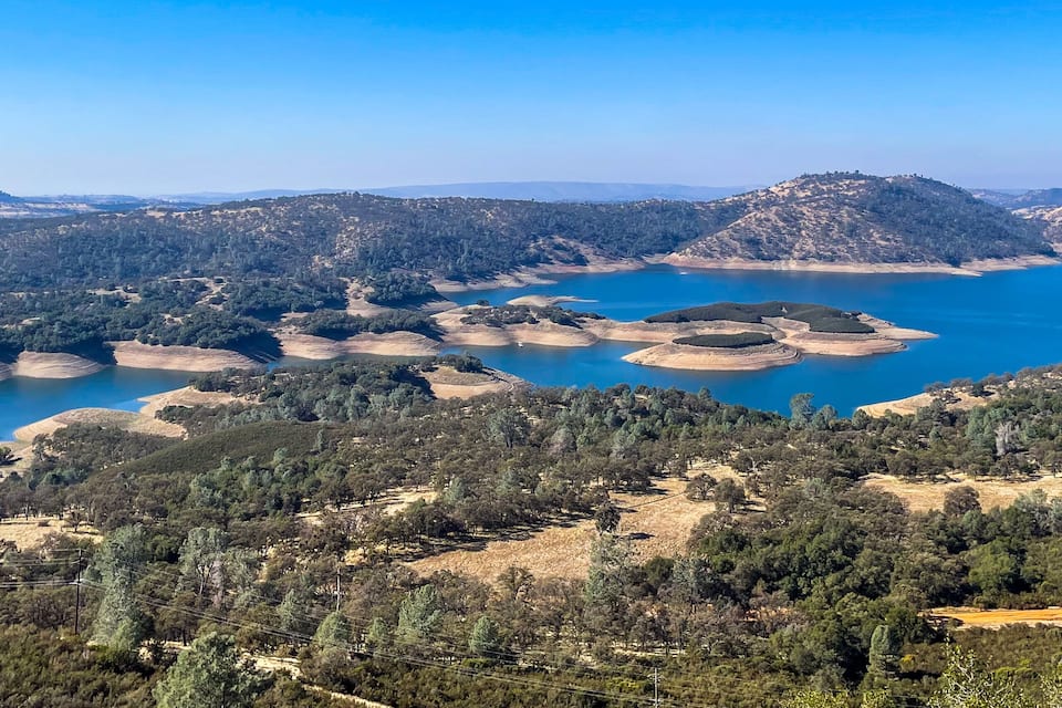 A lake surrounded by hills and trees.