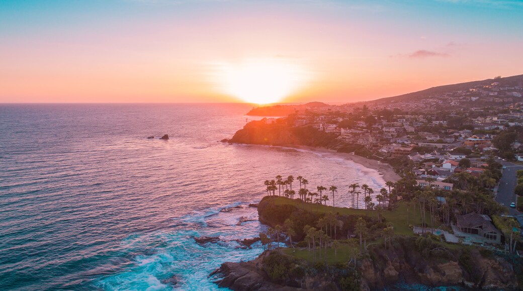 Aerial view over Crescent Bay in Laguna Beach at sunset overlooking Orange County beaches.