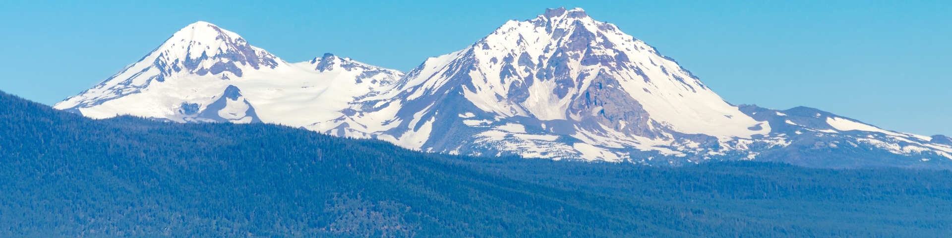 View of the snow covered Three Sisters mountains in the Cascade Range