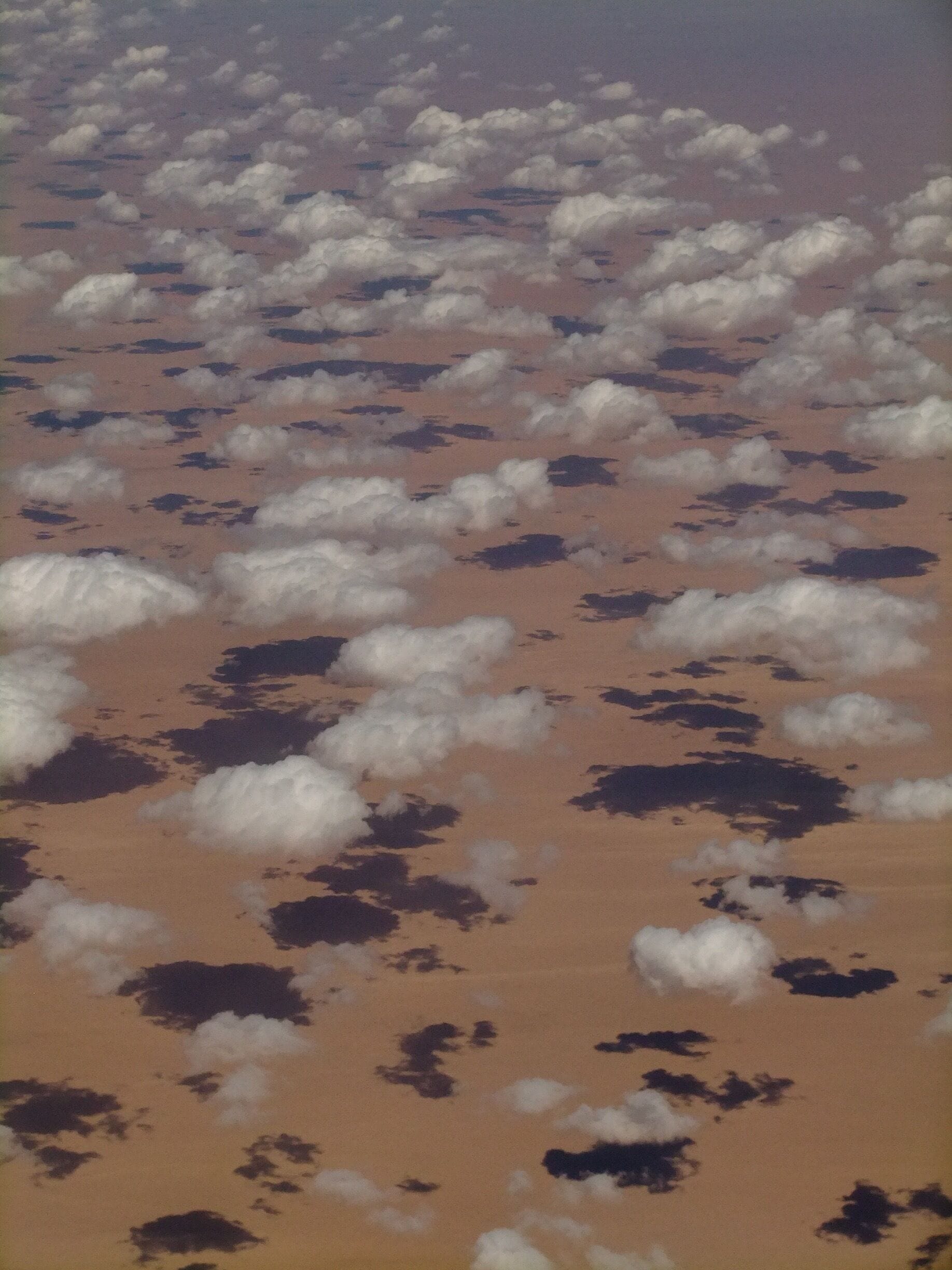 Flying over the Sahara these clouds made an interesting pattern on the sand 