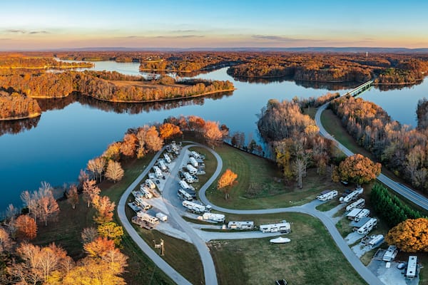 Aerial panorama view of an RV, motor home family camp site in autumn with mountains in the background on Tims Ford Lake in Tennessee USA.