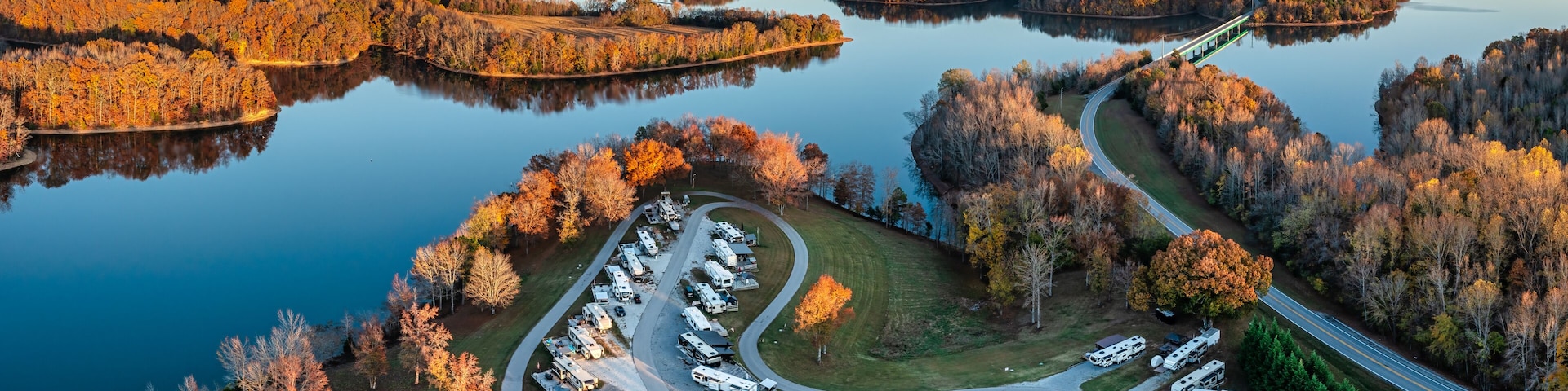 Aerial panorama view of an RV, motor home family camp site in autumn with mountains in the background on Tims Ford Lake in Tennessee USA.