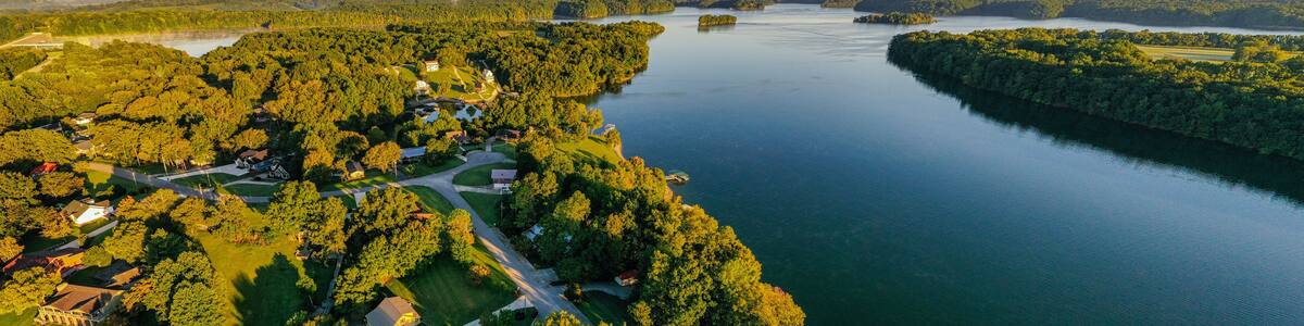 Aerial panorama view of lakefront and lake view homes, golf course and floating boat docks on Tims Ford Lake in Tennessee.