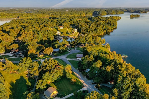 Aerial panorama view of lakefront and lake view homes, golf course and floating boat docks on Tims Ford Lake in Tennessee.
