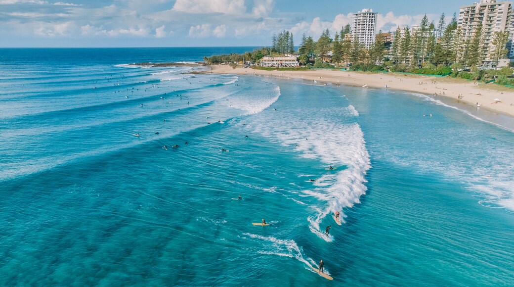 An aerial view of surfers and swimmers at Rainbow Bay, Gold Coast, Australia