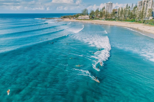 An aerial view of surfers and swimmers at Rainbow Bay, Gold Coast, Australia