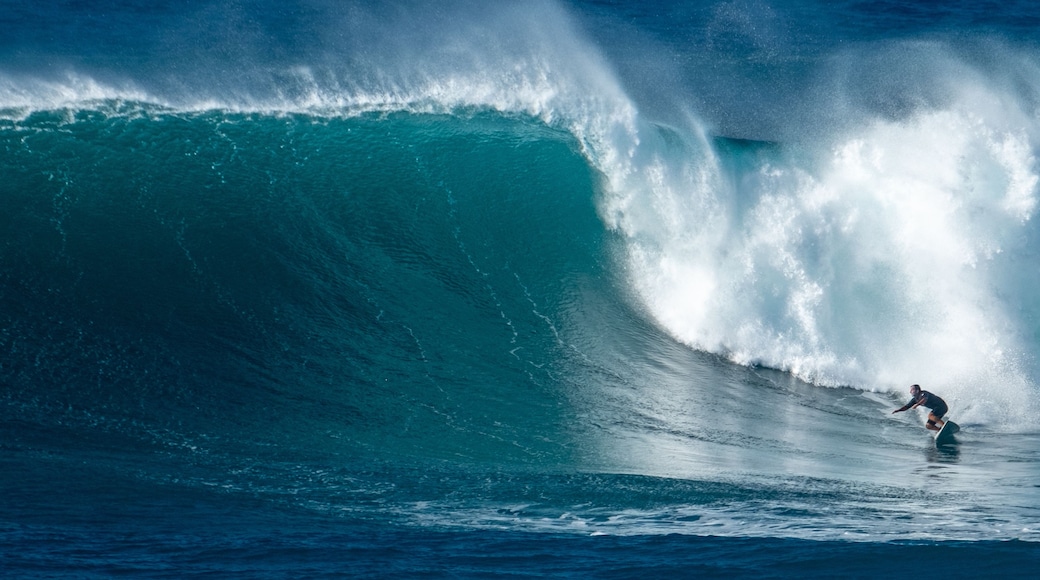 Un surfista cabalgando una ola grande en el océano.