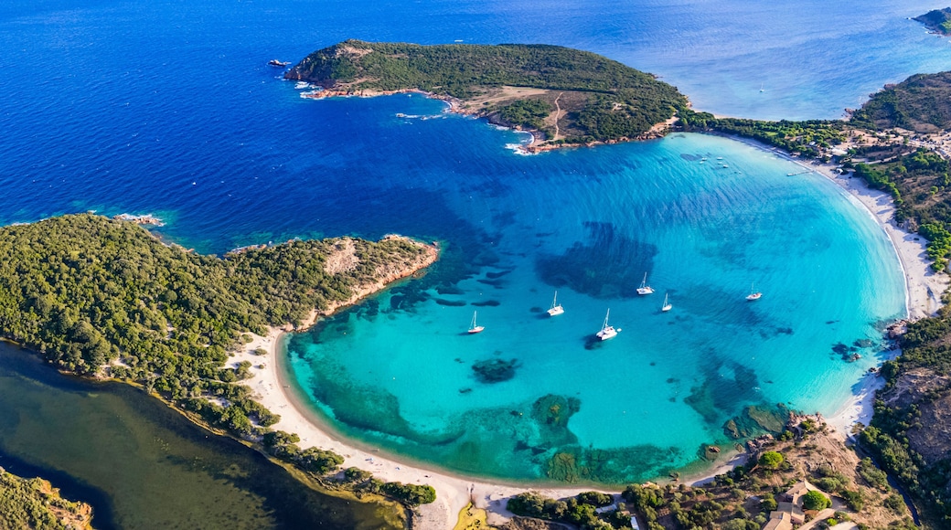 Best beaches of Corsica island - aerial panoramic view of beautiful Rondinara beach with perfect round shape and crystal turquoise sea.