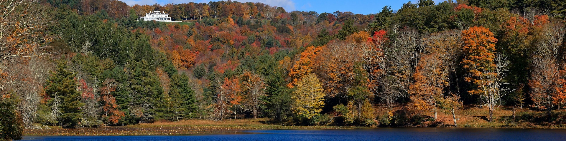 Cone Manor House near Blowing Rock, NC in the distance with Bass Lake in the foreground
