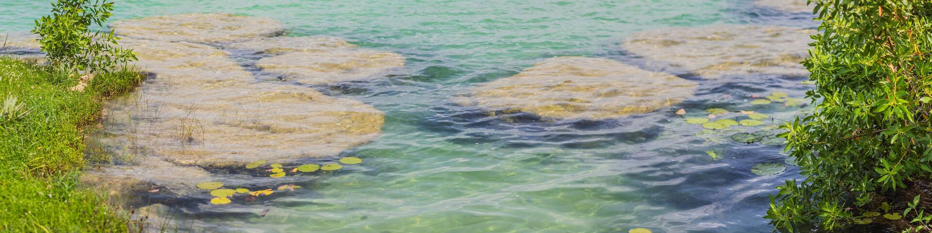 Stromatolites in the crystal-clear waters of Bacalar Lake, Mexico. Ancient natural formations in a stunning tropical setting. Nature, geology, and travel concept