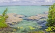 Stromatolites in the crystal-clear waters of Bacalar Lake, Mexico. Ancient natural formations in a stunning tropical setting. Nature, geology, and travel concept