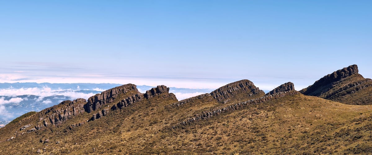 A mountain range with sharp peaks and a clear sky.