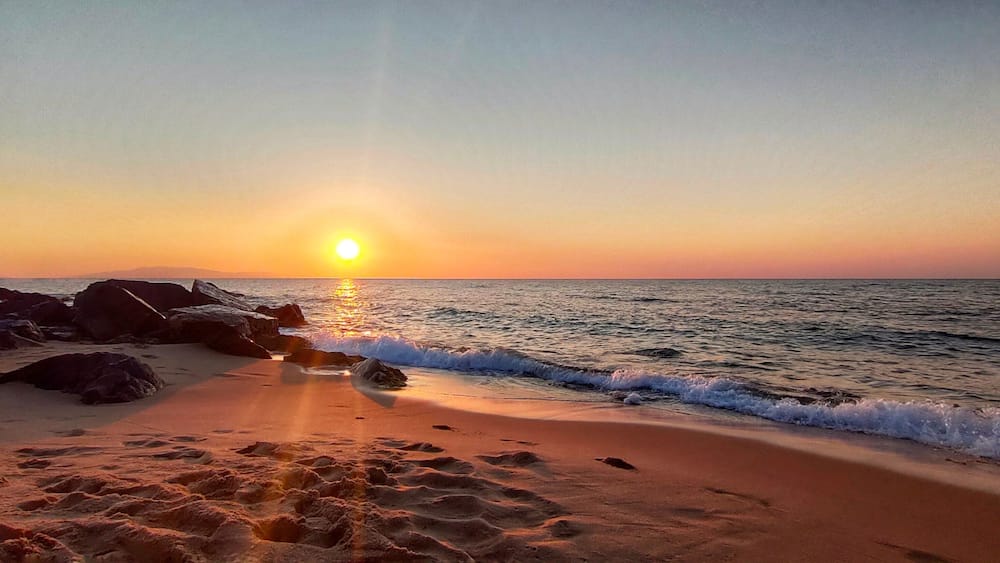 view on the waves crashing on the sandy beach at sunset in El Tarf. Algeria