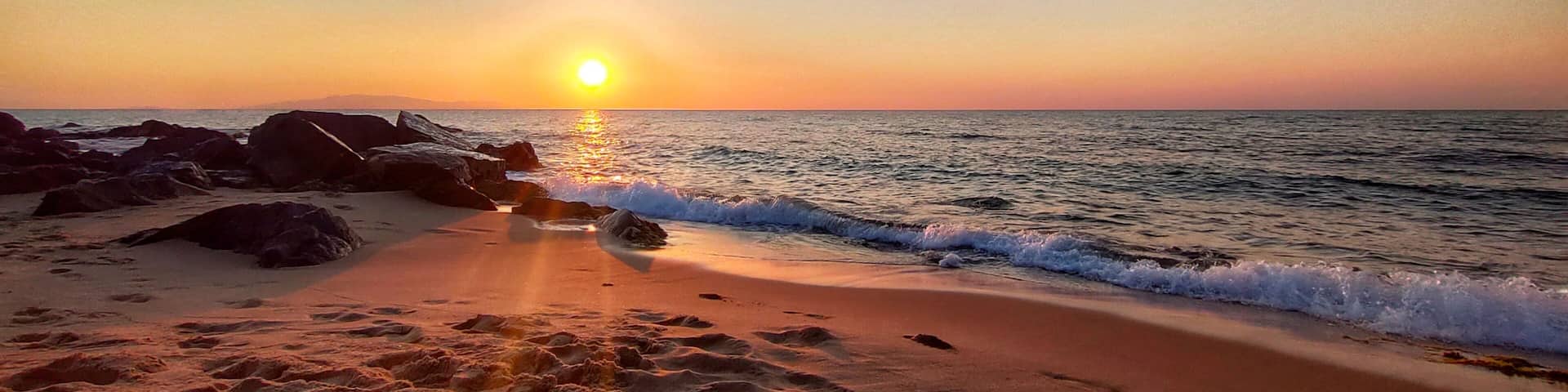 view on the waves crashing on the sandy beach at sunset in El Tarf. Algeria