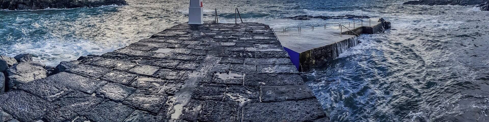 From the port of Caloura between heavy showers and sunshine. Not the day to take a swim.