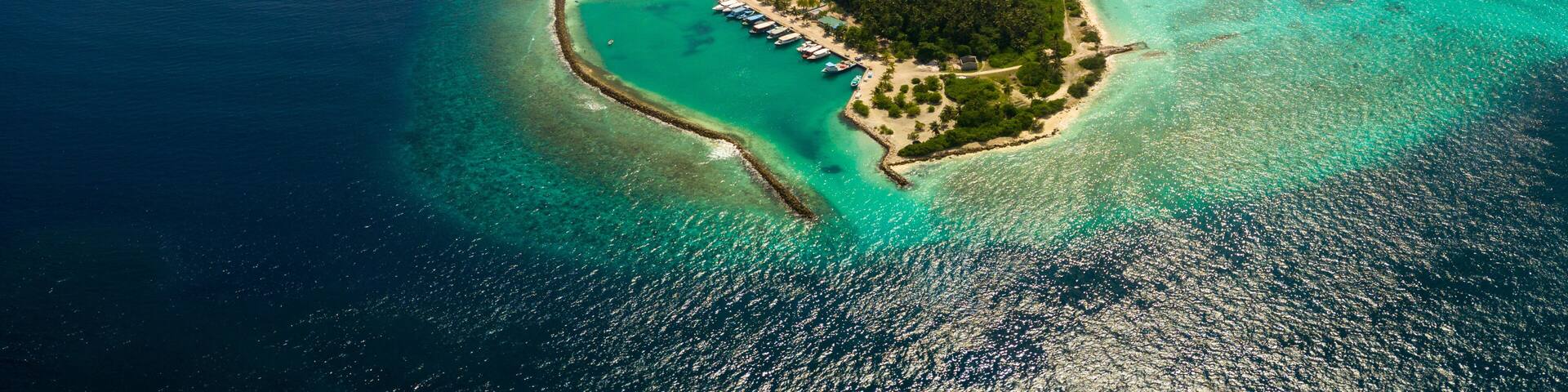 Aerial spherical panorama of tropical paradise beach on tiny Maldives island Dhigurah. Turquoise ocean, white sand, coconut palm trees.