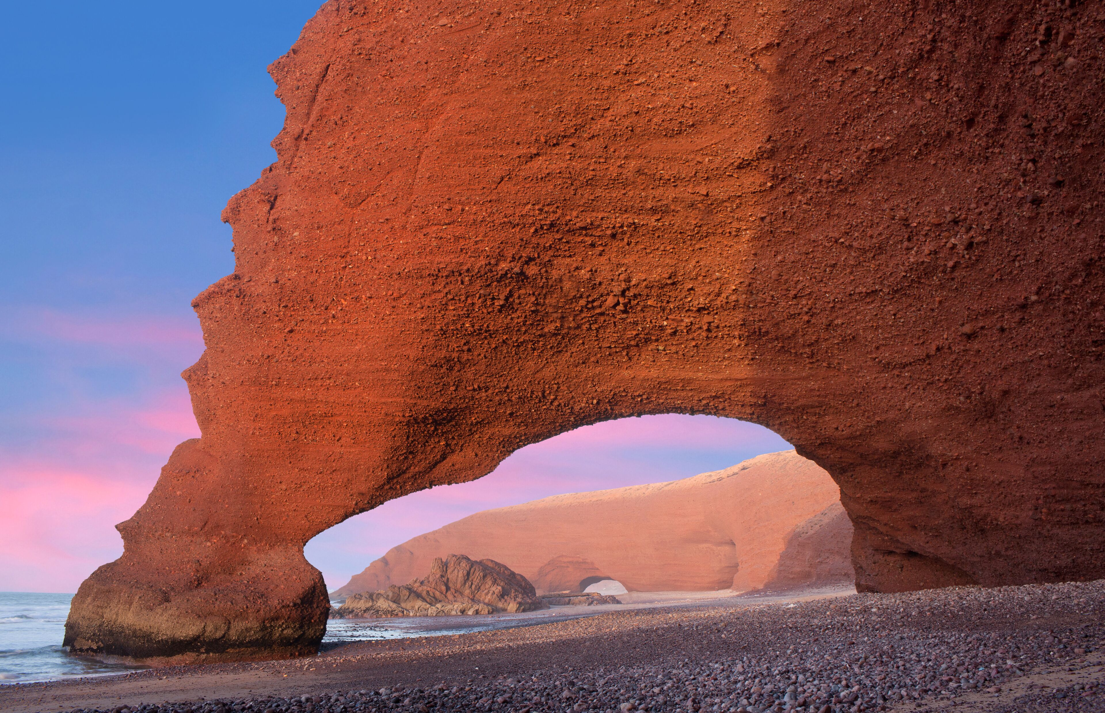 Famous Red arches at Legzira beach near Sidi Ifni on Atlantic coast in Morocco, Northern Africa. One of two rock archways has collapsed in 2016.