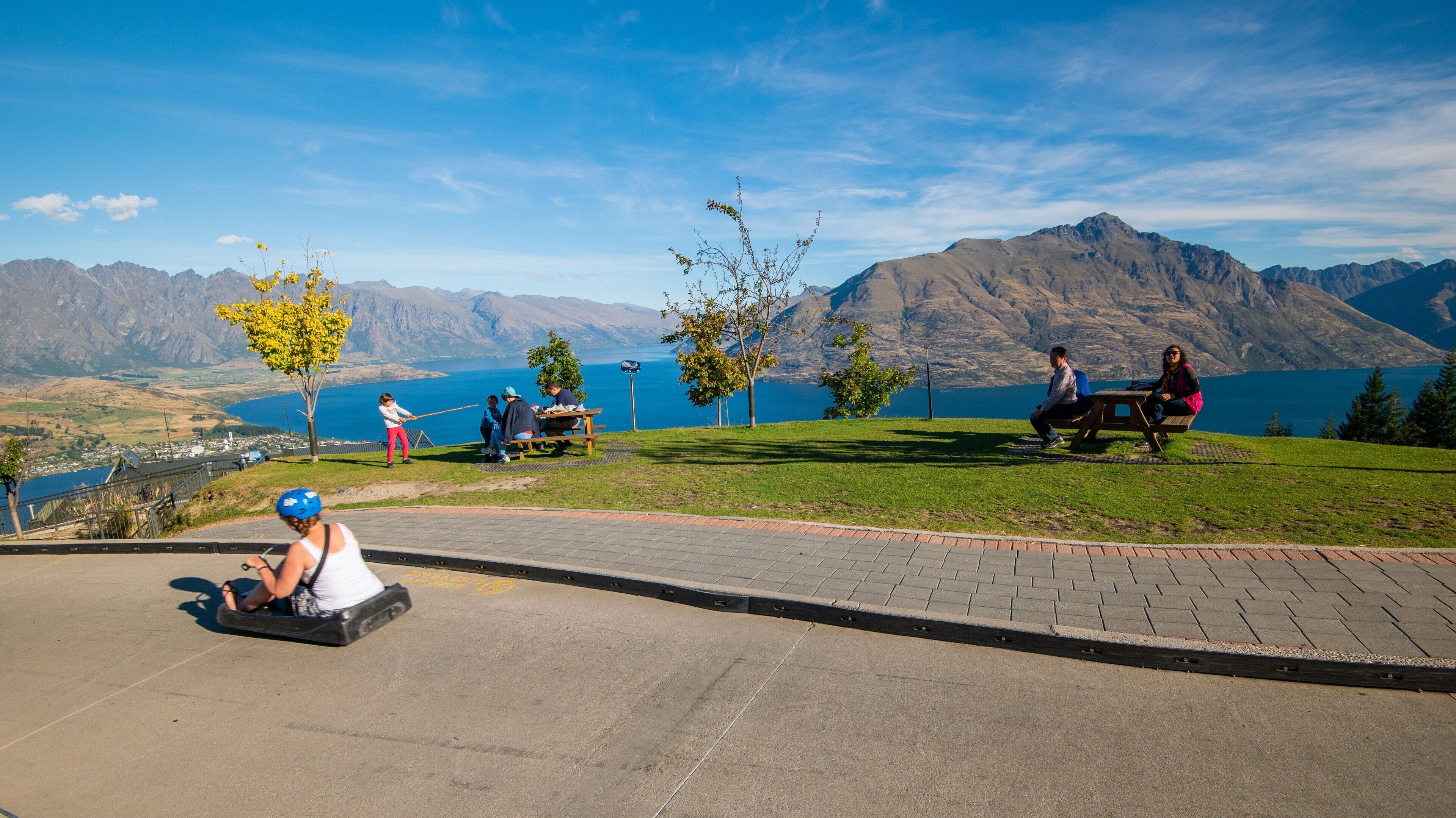 Skyline Luge featuring a park as well as an individual femail