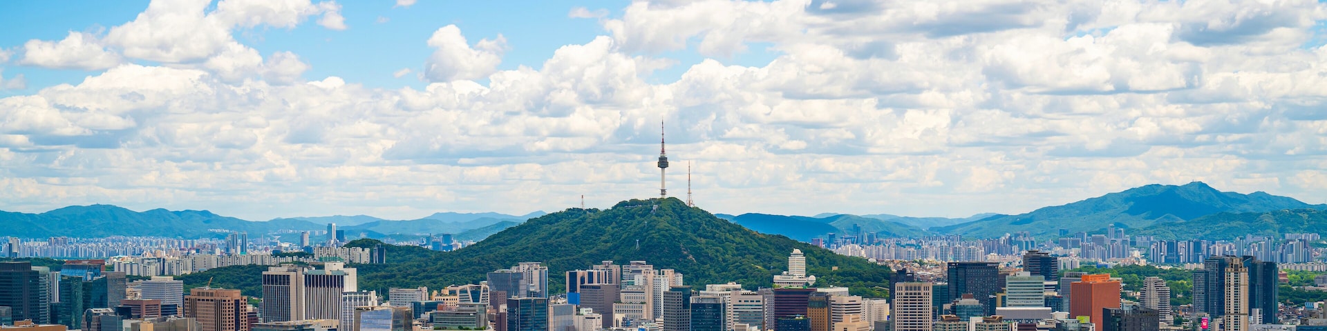 Beautiful cloudy day. The bright blue sky contrasts with floating white clouds,vibrant atmosphere of the city. Perfect for travel ads, urban lifestyle content.