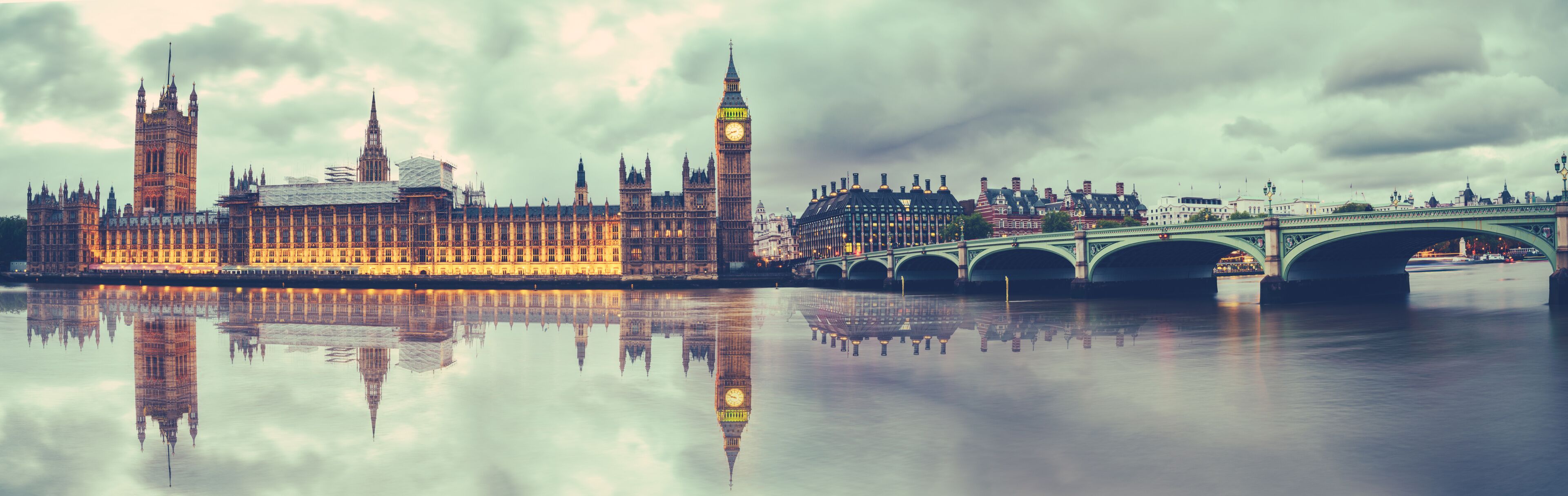 Panoramic view of Houses of Parliament, Big Ben and Westminster Bridge with reflection, London