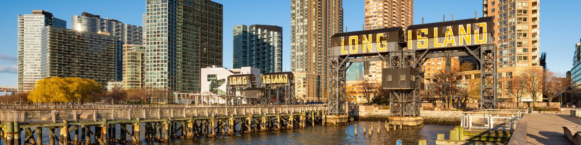 Long Island City waterfront at Gantry Plaza State Park, Queens, New York City, with iconic gantries, piers and modern residential towers in late day light