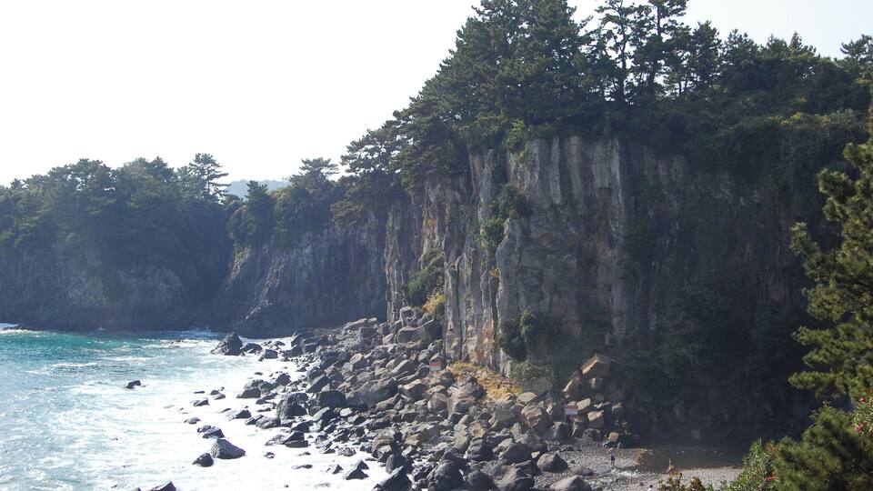 Near the Jeongbang Waterfall 정방폭포. The waterfall is 23 meters high and is very close to the ocean.