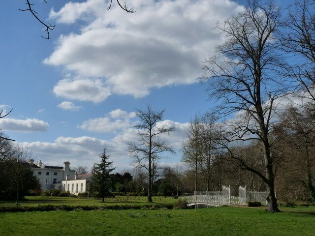 Parkland in Morden Hall Park Morden Hall stands in the distance, but is not open to the public. In the foreground, the bridge crosses over the river.
