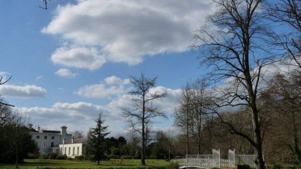 Parkland in Morden Hall Park Morden Hall stands in the distance, but is not open to the public. In the foreground, the bridge crosses over the river.