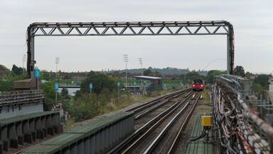 A Jubilee Line 1996 Stock train approaches Canons Park tube station, working a service to Stanmore.