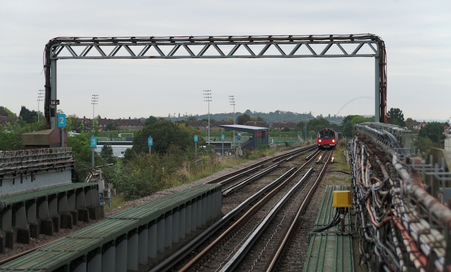 A Jubilee Line 1996 Stock train approaches Canons Park tube station, working a service to Stanmore.