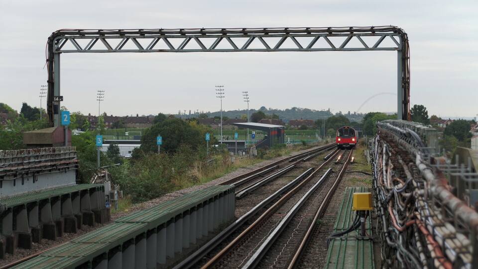 A Jubilee Line 1996 Stock train approaches Canons Park tube station, working a service to Stanmore.