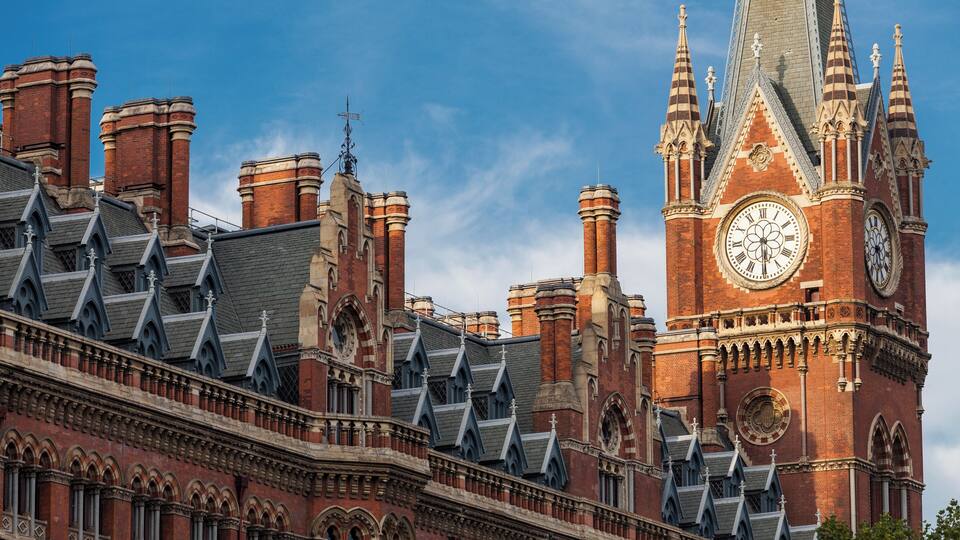 A historic building with a prominent clock tower and intricate architectural details.