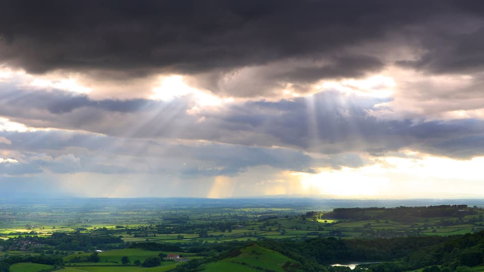 Panoramic view from Sutton Bank with Crepuscular Rays coming through the clouds. North Yorkshire, England, UK.