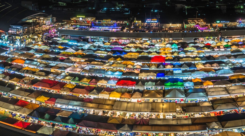 Panorama landscape view colorful of plastic roof of tent at ratchada train night market with dark sky of bangkok city. popular place for shopping at night.