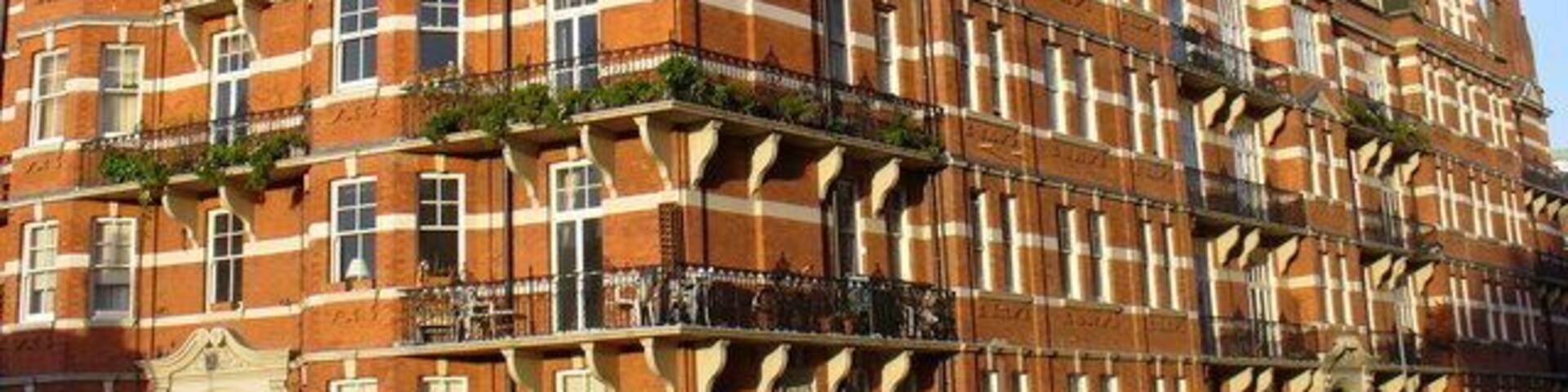 Glyn Mansions This grandiose Victorian block of flats dates from 1897 and lies just south of Olympia. Note the fancy gables, wrought iron balconies, ornate doorway and the limestone banding in the brickwork.