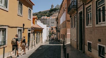 Mouraria featuring street scenes as well as a couple