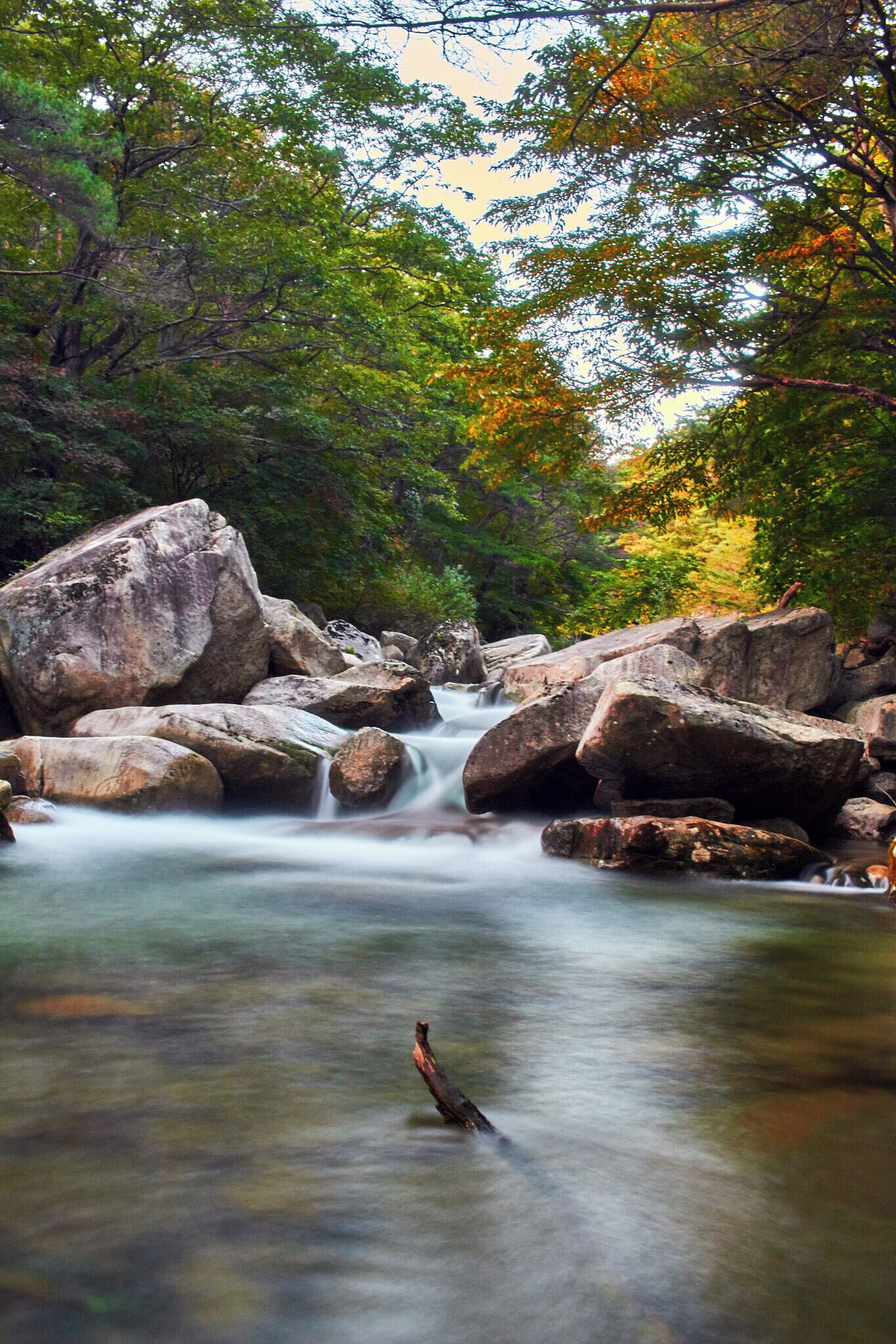 500px provided description: River at Munkyoung South Korea. Visit my <a href="www.smart-art.org">website</a> for more creative work outside of photography. [#trees ,#color ,#water ,#nature ,#river ,#rocks ,#asia ,#waterfall ,#long exposure ,#stream ,#south korea ,#korea]