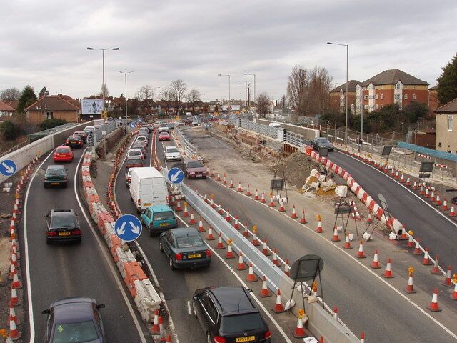 Traffic on temporary bridge during replacement. Two railway bridges on the dual carriageway A40 in Acton are being replaced - see 313384 for earlier photo and more information. This is Perryn Road bridge, across the London Overground railway. At present there are temporary bridges each for one lane of traffic either side of the original bridge, and pedestrian/cycle bridges hanging outside. The original westbound carriageways have one lane each way at present, the original eastbound carriageways are not in use while the bridge below them is replaced. Lots of traffic cones, and rather confusing for traffic, there is a speed limit. Photo from footbridge.