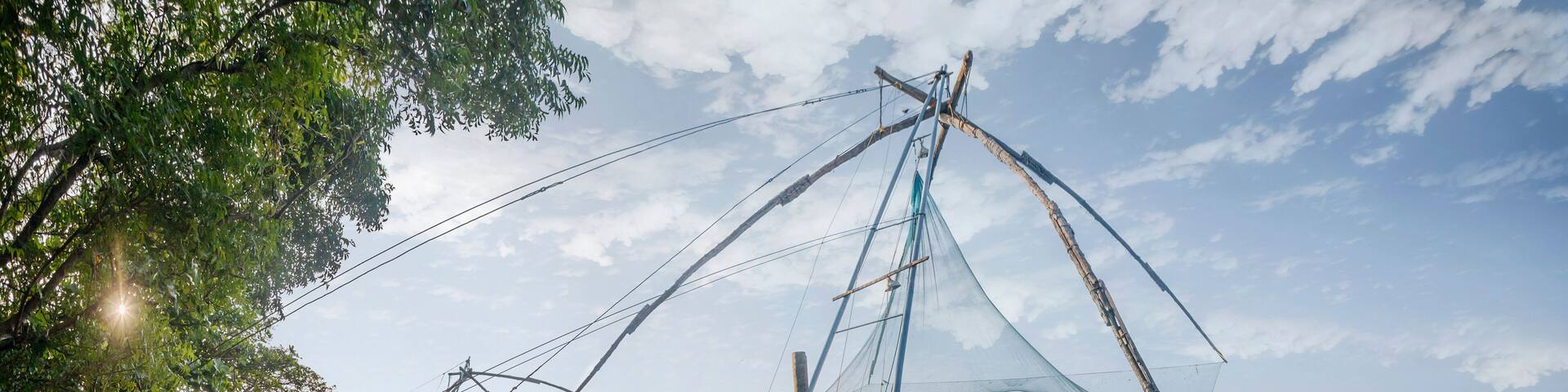 KOCHI, INDIA - OCTOBER 1 , 2018: Ocean coast landscape with chinese fishing nets silhouette at Cochin (Kochi). South India, Kerala, Kochin