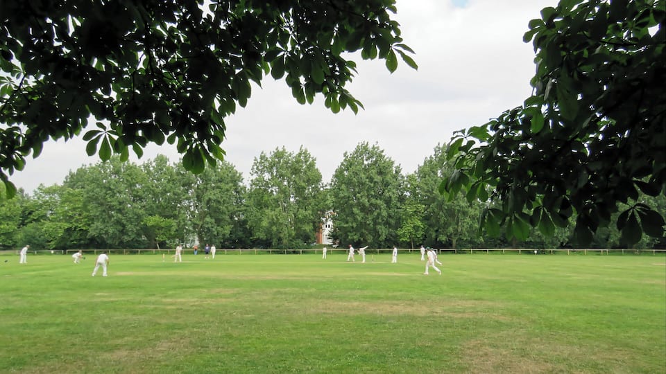A public Sunday cricket match between Woodford Green CC Sunday 'B' XI and Hackney Marshes CC 1st XI (Hackney batting) at Woodford Green, Woodford, East London, England, in June 2018. Woodford Green CC fields three Saturday teams in the Shepherd Neame Essex League, a Twenty20 team, a Midweek team, two Sunday friendly teams, and seven junior section teams. Camera: Canon PowerShot SX60 HS Software: File lens-corrected, optimized, perhaps cropped, with DxO PhotoLab, and likely further optimized with Adobe Photoshop CS2.