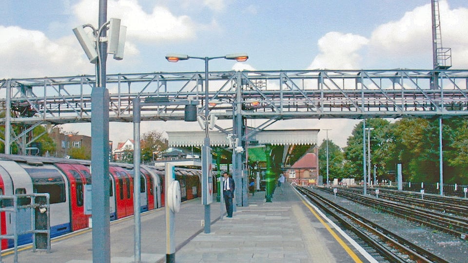 Woodford Station. View northward, towards Loughton and Epping, also Hainault: formerly the ex-GER Liverpool Street - Leyton - Loughton - Epping line, junction of Fairlop Loop via Hainault to Ilford. Passenger services were taken over by the LPTB Central Line in 1946-49, those on the Fairlop Loop south of Hainault using a new Tube tunnel between Leytonstone and Newbury Park; freight traffic ceased after 4/66. The Central Line Underground train on the left was probably from Ealing Broadway to Hainault.