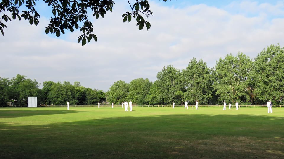 A public Sunday cricket match between Woodford Green CC Sunday 'B' XI and Hackney Marshes CC 1st XI (Hackney batting) at Woodford Green, Woodford, East London, England, in June 2018. Woodford Green CC fields three Saturday teams in the Shepherd Neame Essex League, a Twenty20 team, a Midweek team, two Sunday friendly teams, and seven junior section teams. Camera: Canon PowerShot SX60 HS Software: File lens-corrected, optimized, perhaps cropped, with DxO PhotoLab, and likely further optimized with Adobe Photoshop CS2.
