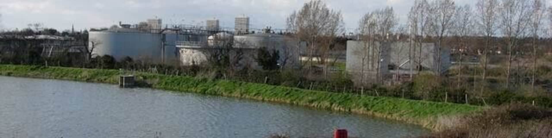 Hogsmill sewage works The buildings house mechanical sludge driers (compressors) which replaced sludge drying lagoons in the late 90's. The pool in the foreground was left in mitigation for the loss of the wildlife value that the sludge lagoons had.