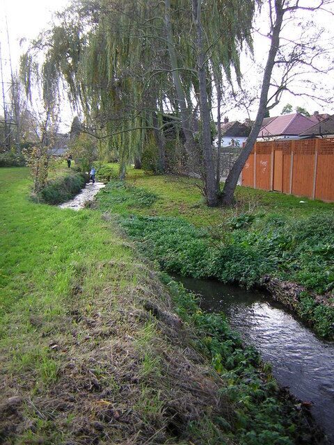 The River Shuttle looking towards Albany Road Looking upstream to where electricity power lines cross the river. The Shuttle Riverway follows the river.