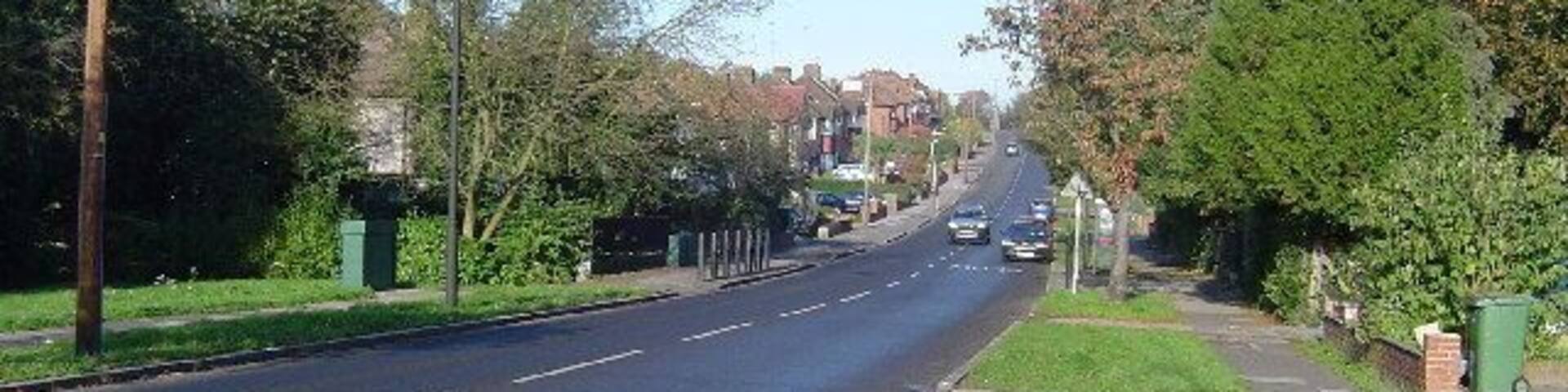 Pinner: Rayners Lane. Viewed looking northwards, Yeading Brook flows under the road at the bottom of the hill.