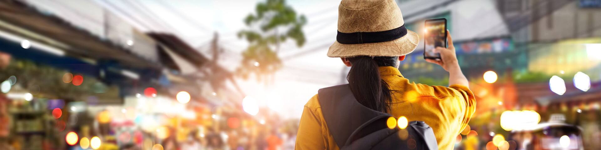 Female tourist traveling backpacker and take a photo in jatujak, chatuchak outdoor market in Bangkok, Thailand